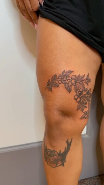 Delicate blueberry branch fine line tattoo.